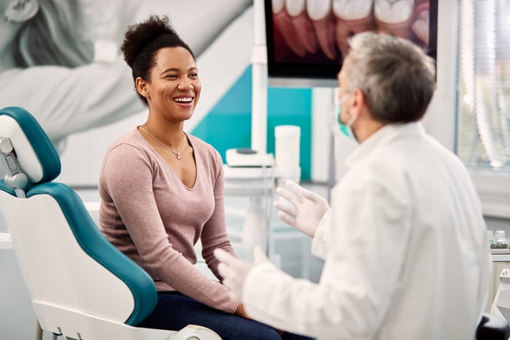 happy-black-woman-talking-to-her-dentist-during-ap-2023-11-27-05-36-07-utc